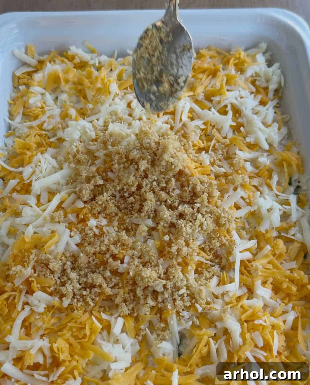 Adding a layer of buttery cracker crumbs over the shredded cheese on the chicken casserole.