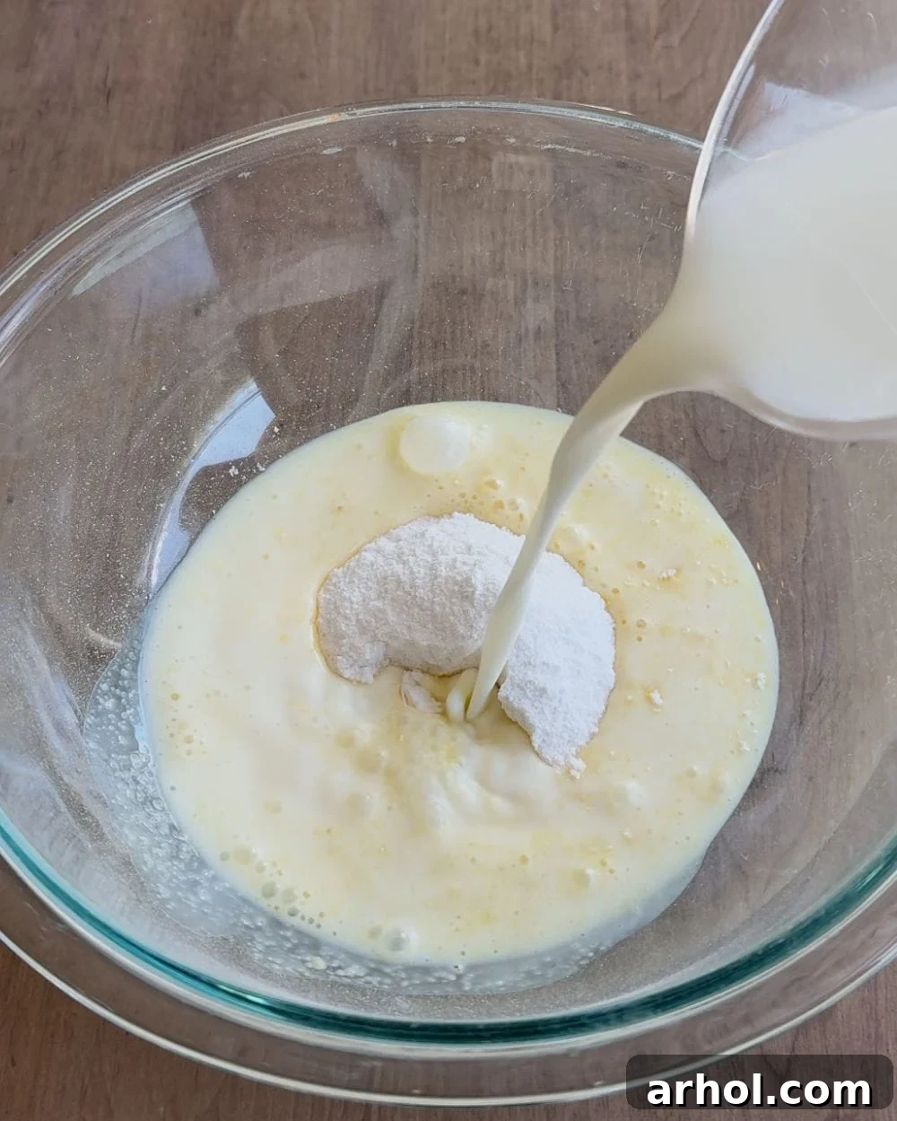 The initial step shows pouring cold milk into a large mixing bowl containing instant vanilla pudding mix.