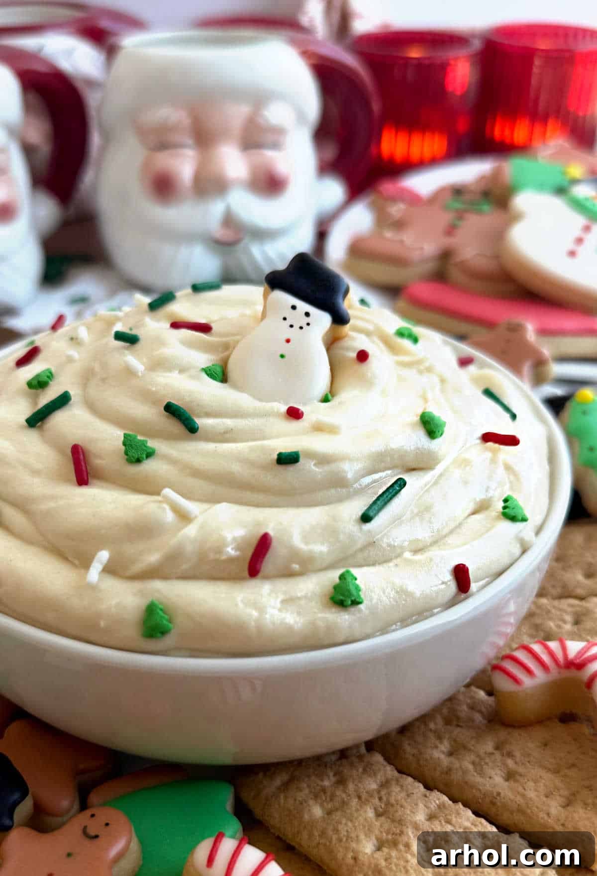 Dreamy Christmas Sugar Cookie Dip 2 bowl of Christmas sugar cookie dip with sprinkles and dippers, looking festive and delicious.