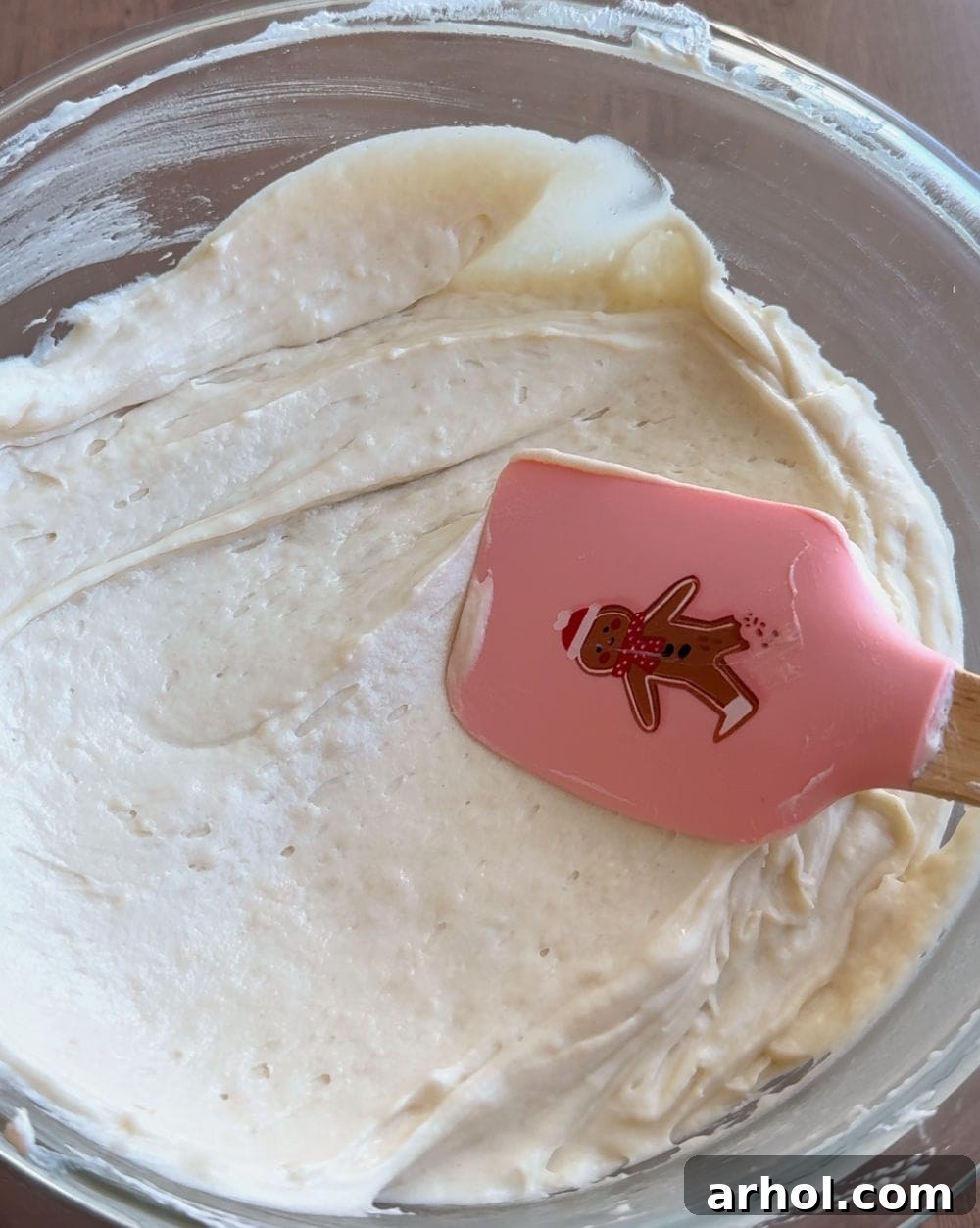 Dreamy Christmas Sugar Cookie Dip 7 mix dip with gingerbread man spatula, showing creamy texture.