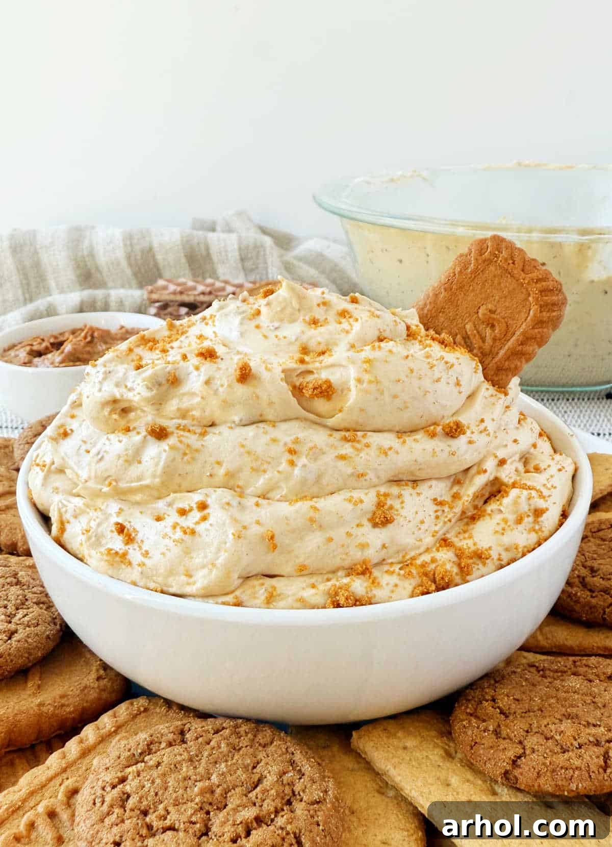 Biscoff cookie butter dip in white serving bowl with cookie dippers.