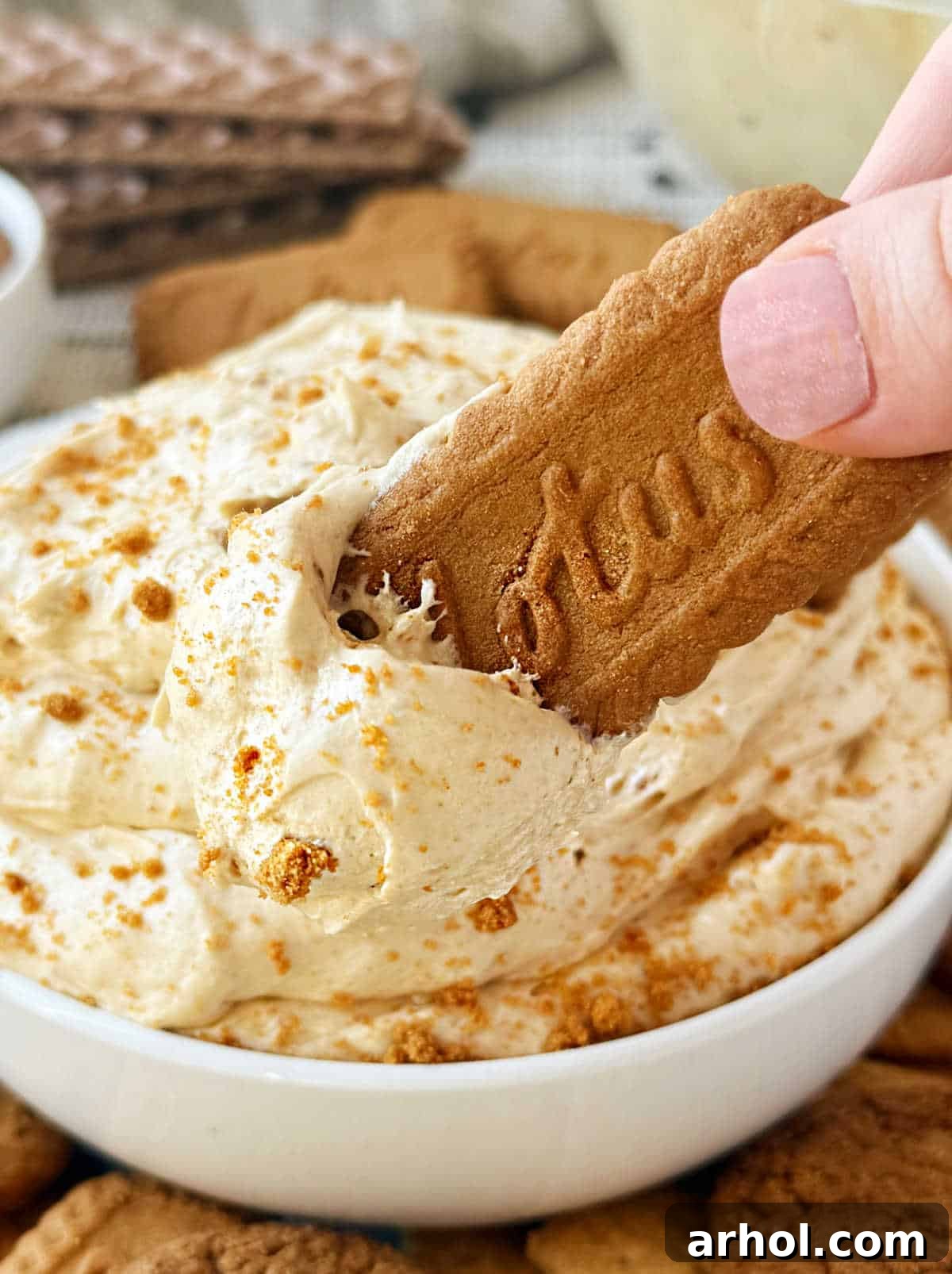 dip Biscoff cookie into cookie butter dip.