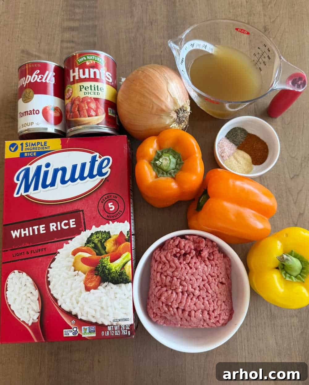 Grandma's Signature Stuffed Peppers 3 ground beef, minute rice, bell peppers and ingredients for recipe.