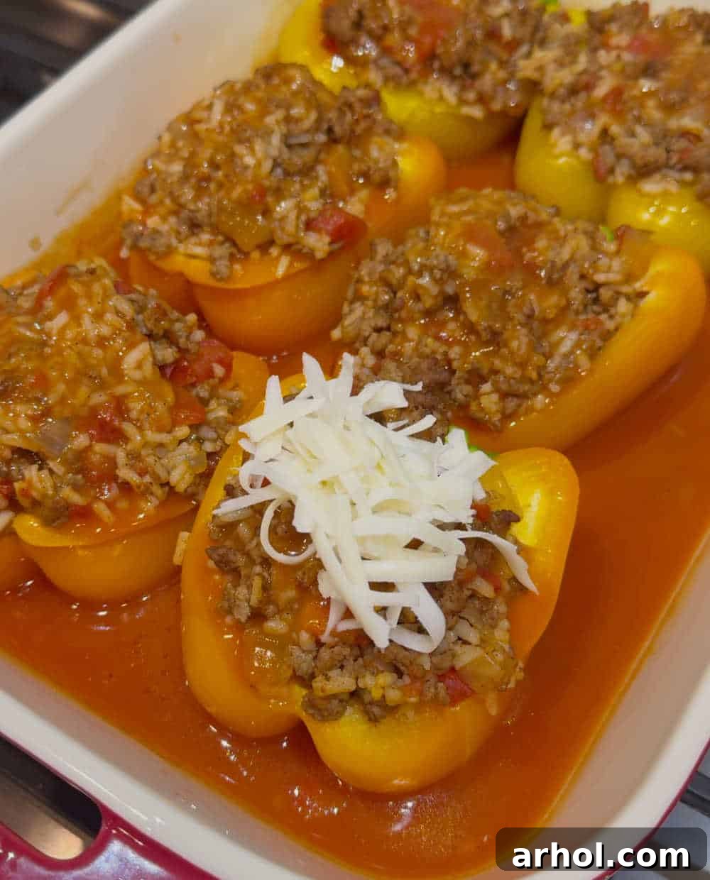 Grandma's Signature Stuffed Peppers 7 top peppers with shredded cheese.