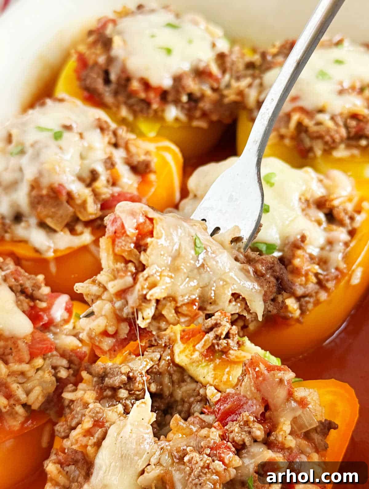 Grandma's Signature Stuffed Peppers 8 fork in baked stuffed bell peppers.