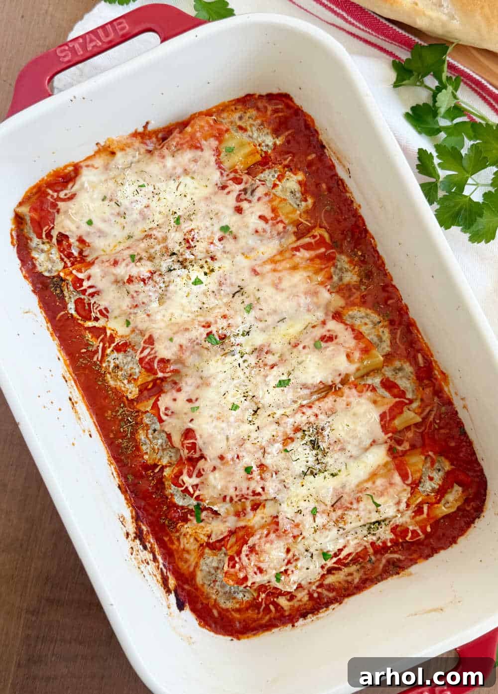 Baked manicotti with meat and cheese in a large casserole dish, fresh from the oven and ready to serve.