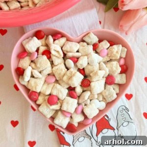 valentine's day puppy chow with valentine m&m candy in bowl.