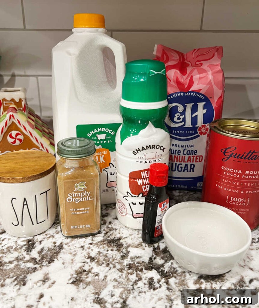 Ultimate Peppermint Hot Chocolate 3 A selection of essential ingredients for preparing homemade peppermint hot cocoa, neatly arranged on a kitchen counter: unsweetened cocoa powder, fresh milk, rich heavy cream, granulated sugar, a pinch of sea salt, warm ground cinnamon, aromatic peppermint extract, and clear water.