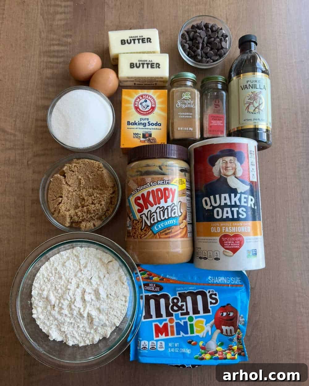 Flour, peanut butter, quick oats, and other essential ingredients laid out for making delicious monster cookie bars.