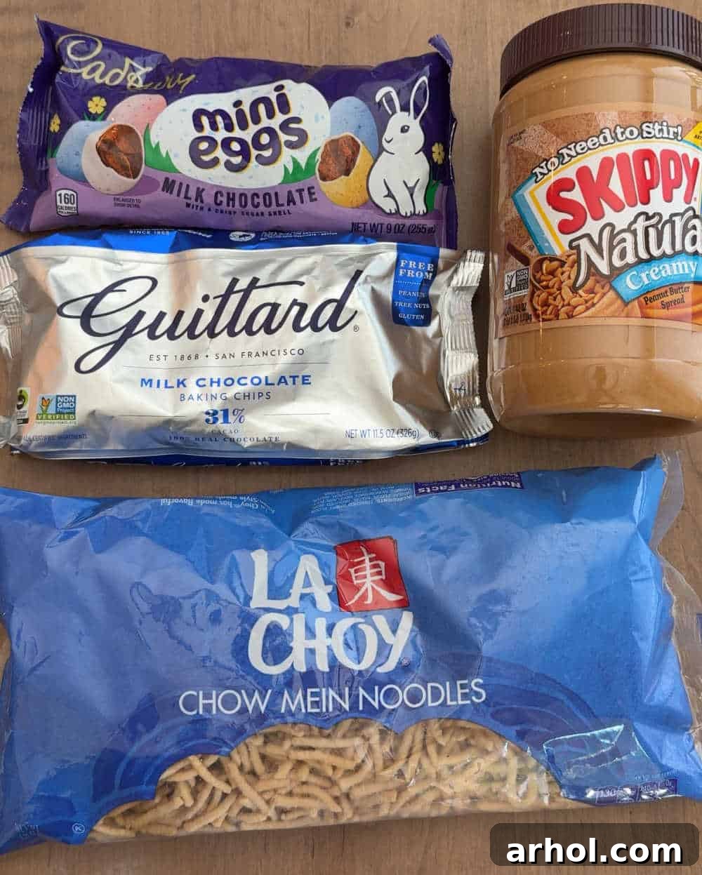 Key ingredients laid out: dried crunchy chow mein noodles, vibrant mini candy eggs, milk chocolate chips, and creamy peanut butter.