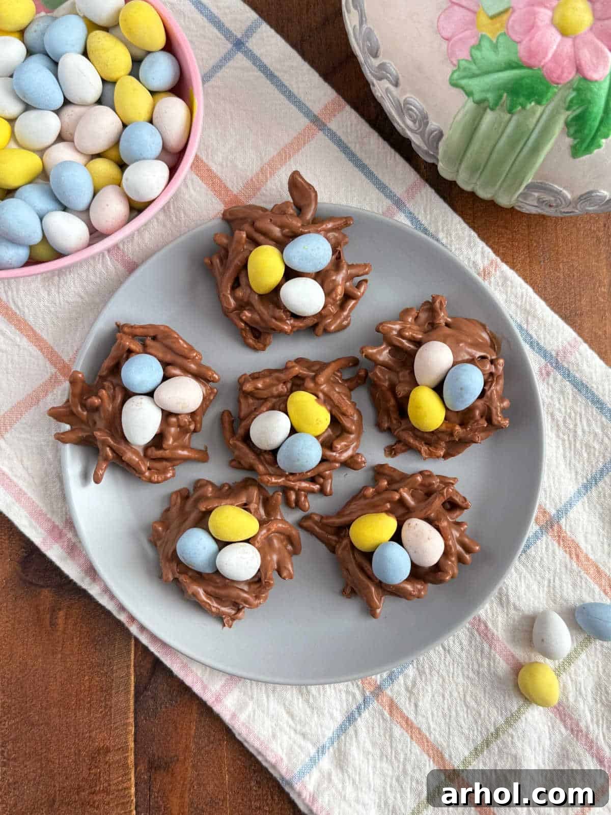A charming plate filled with perfectly set chow mein noodle cookies, garnished with colorful mini eggs.