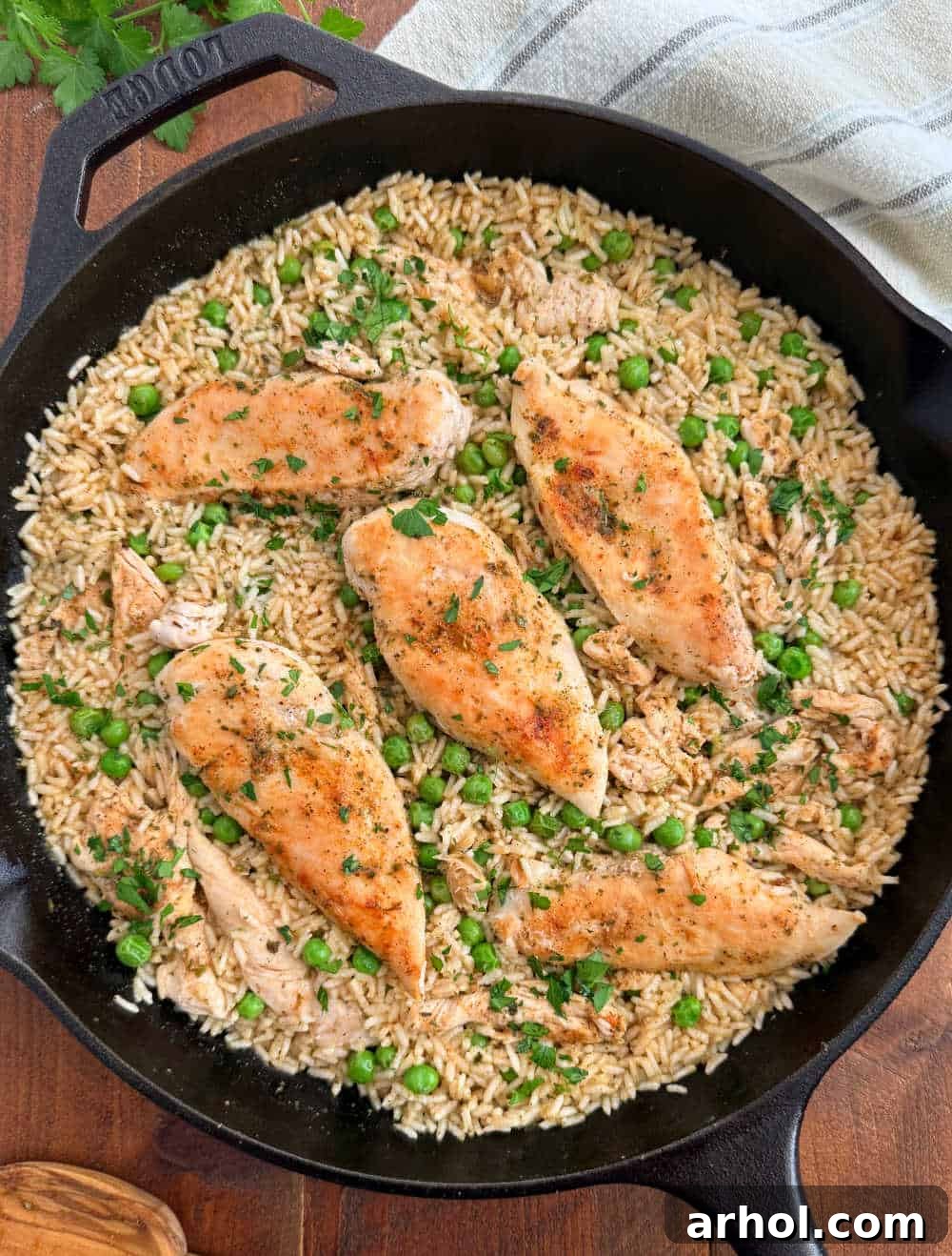 Perfectly cooked chicken and rice with peas, served directly in a cast iron skillet.