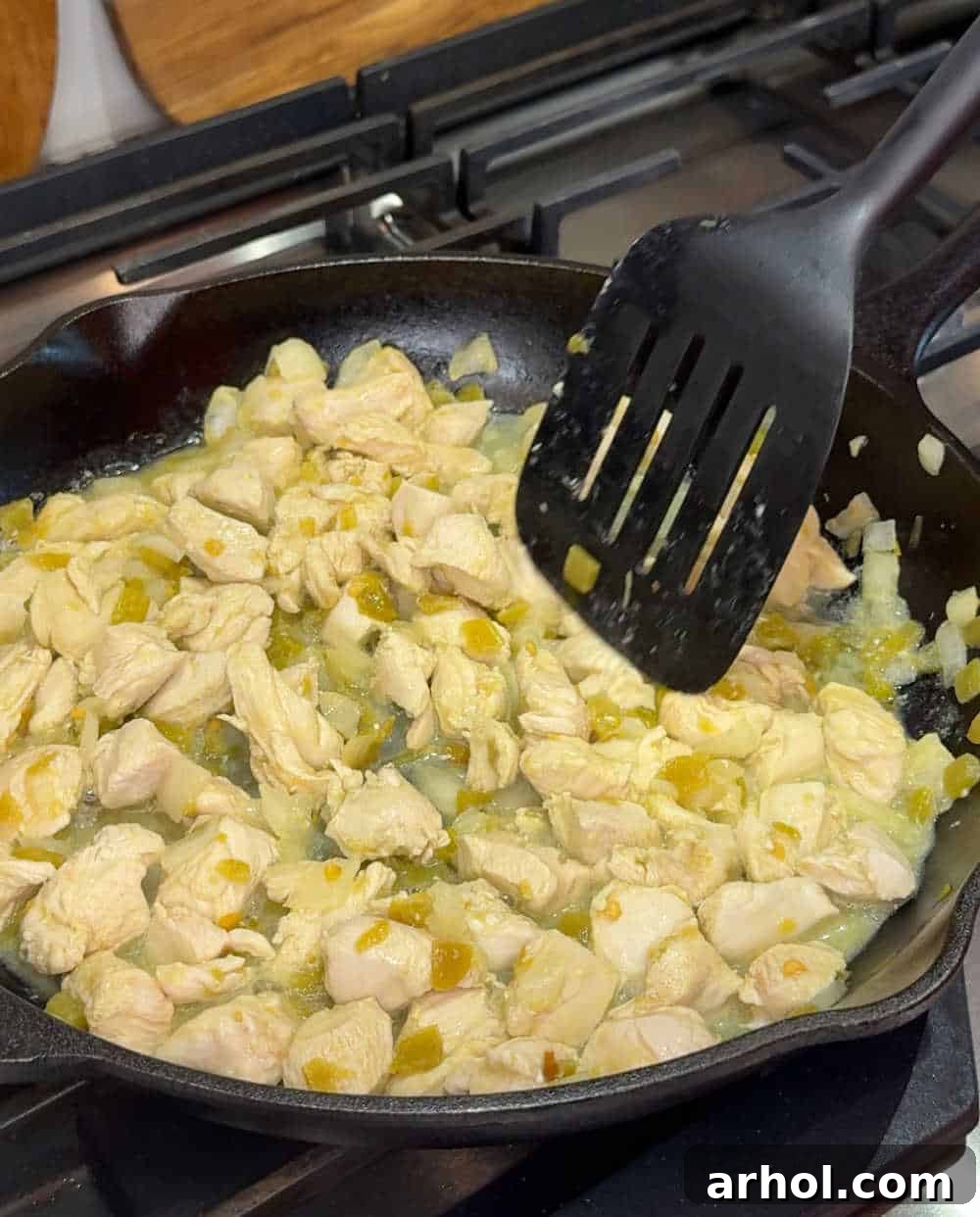 Cooking chicken in a skillet with seasoning.
