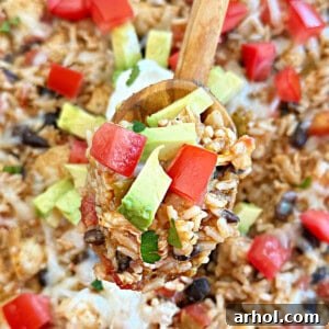 One Pan Mexican chicken and rice on a spoon, ready to serve.