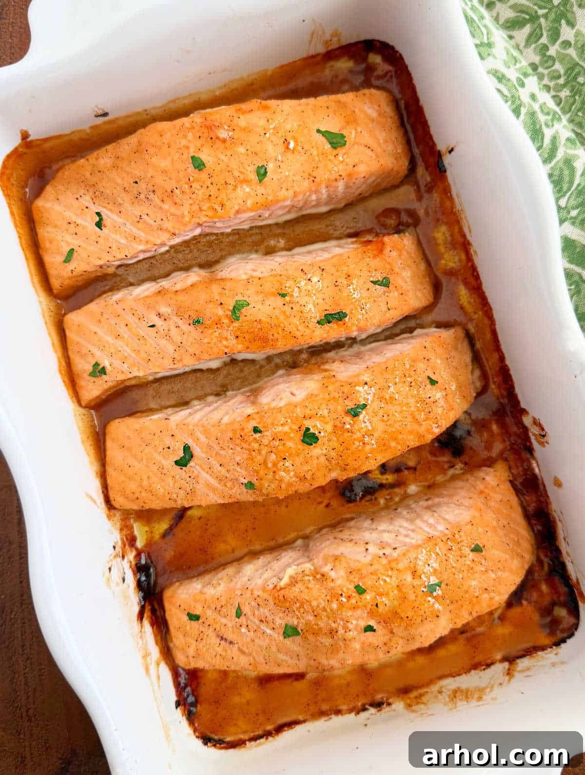 Golden Baked Honey Mustard Salmon 8 baked honey mustard salmon topped with parsley.