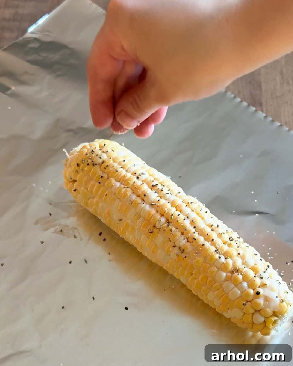 sprinkle seasoning over corn.