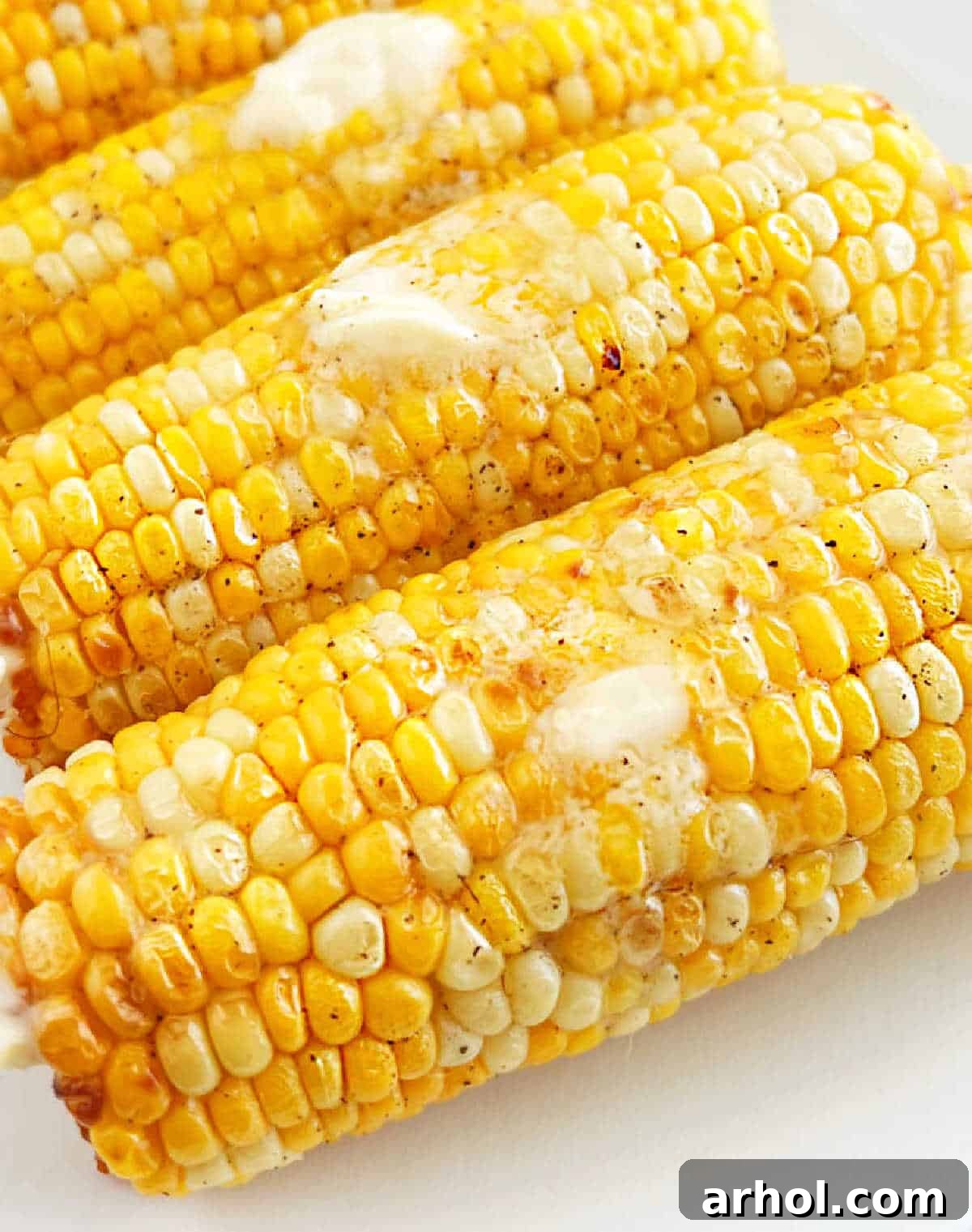 platter of corn with melted butter on top.