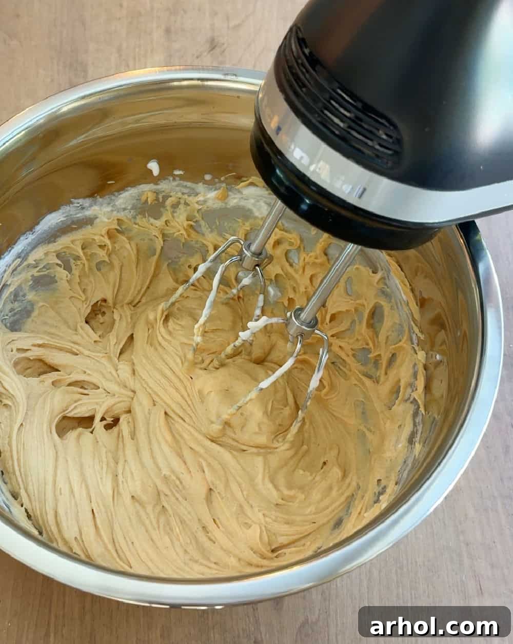 Wag-Worthy Homemade Dog Cake 6 Using an electric mixer to make dog-safe frosting in a bowl.