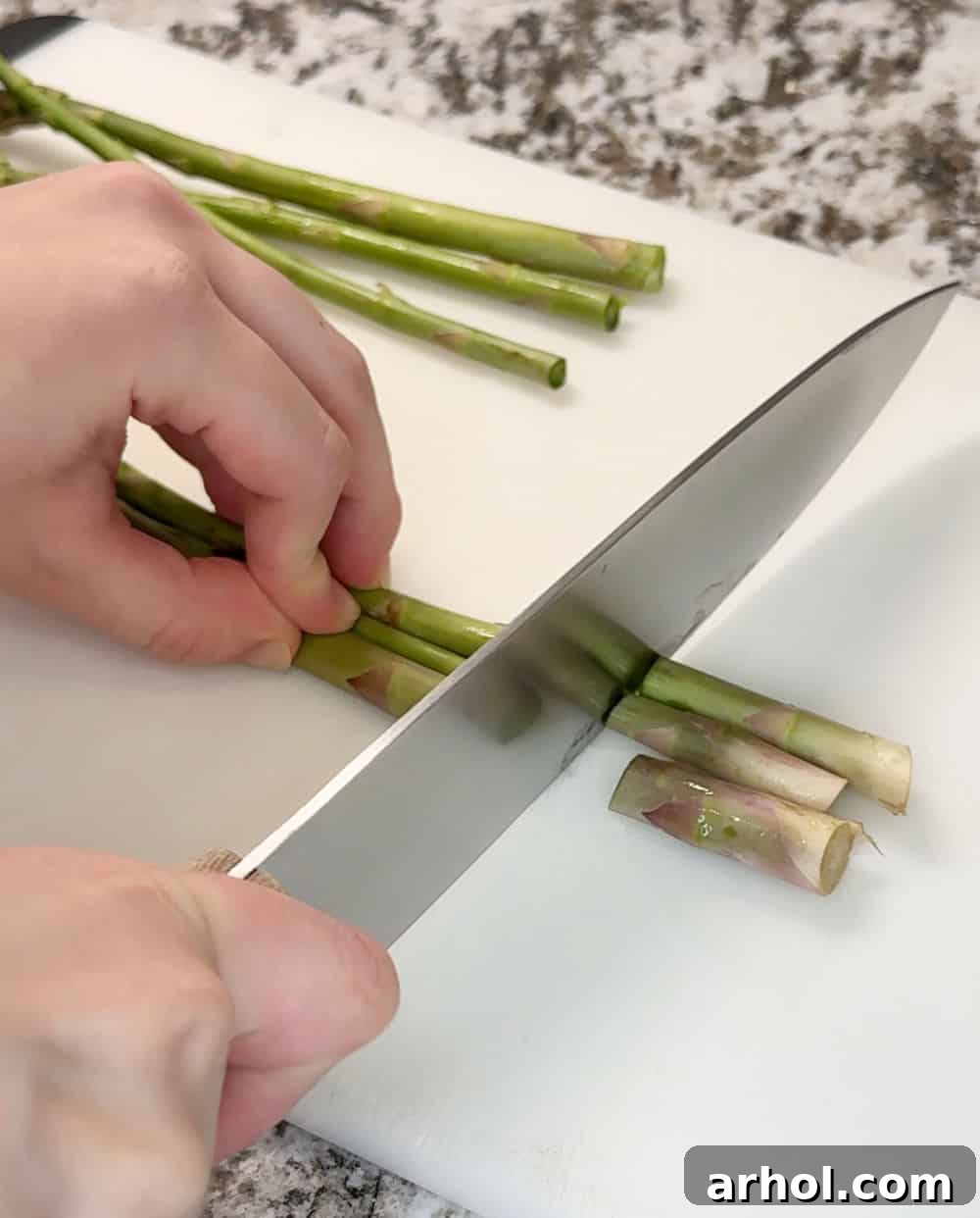 cut ends off asparagus with knife.
