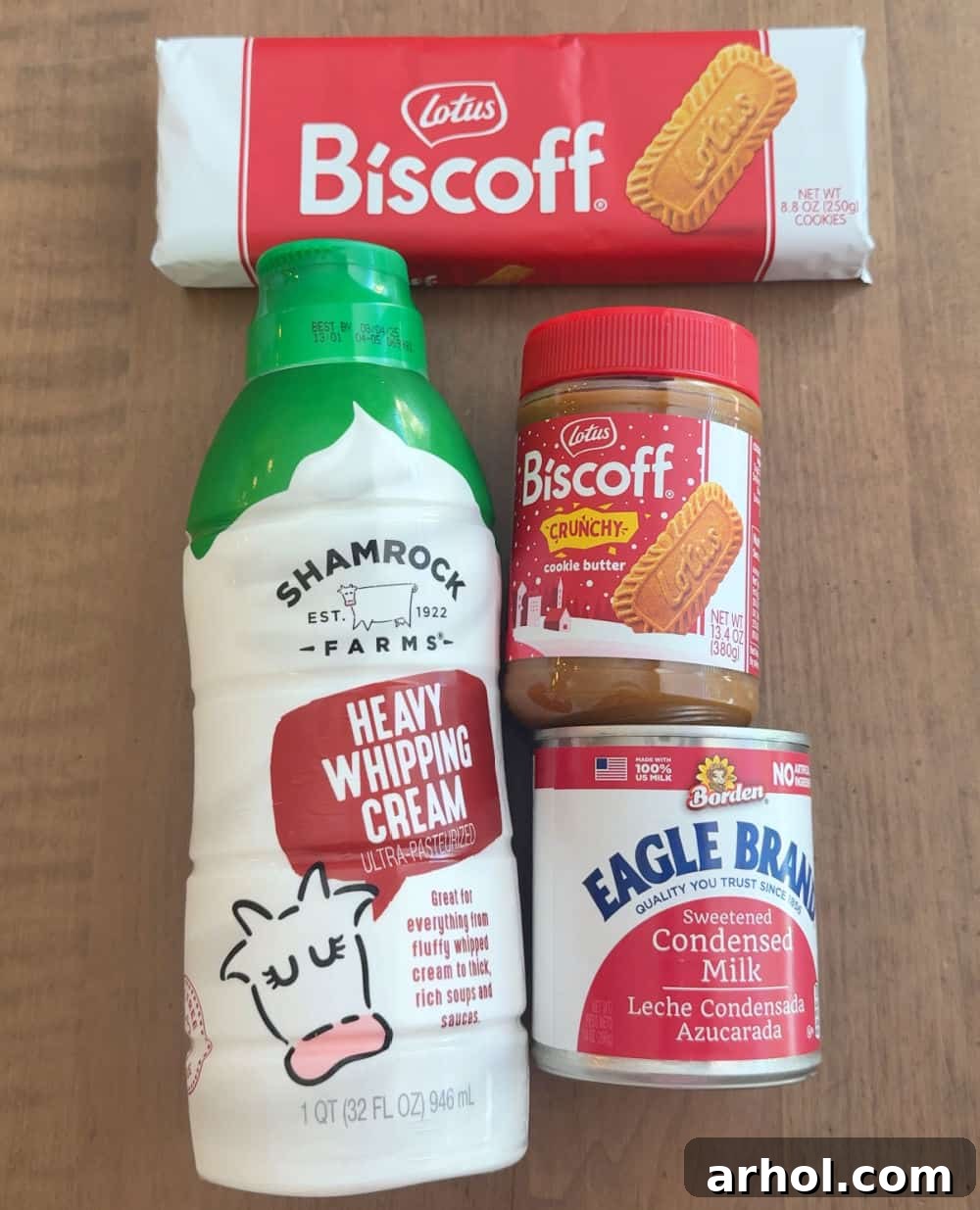 Biscoff cookies, jar of cookie butter, heavy cream, and sweetened condensed milk laid out as main ingredients.