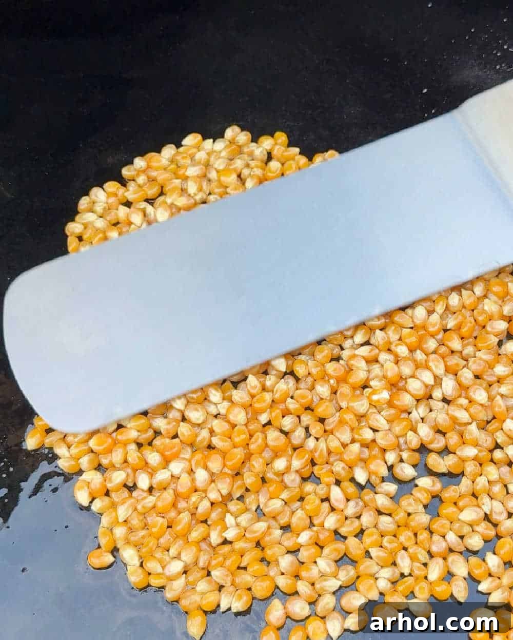 smooth kernels with grill spatula on griddle.