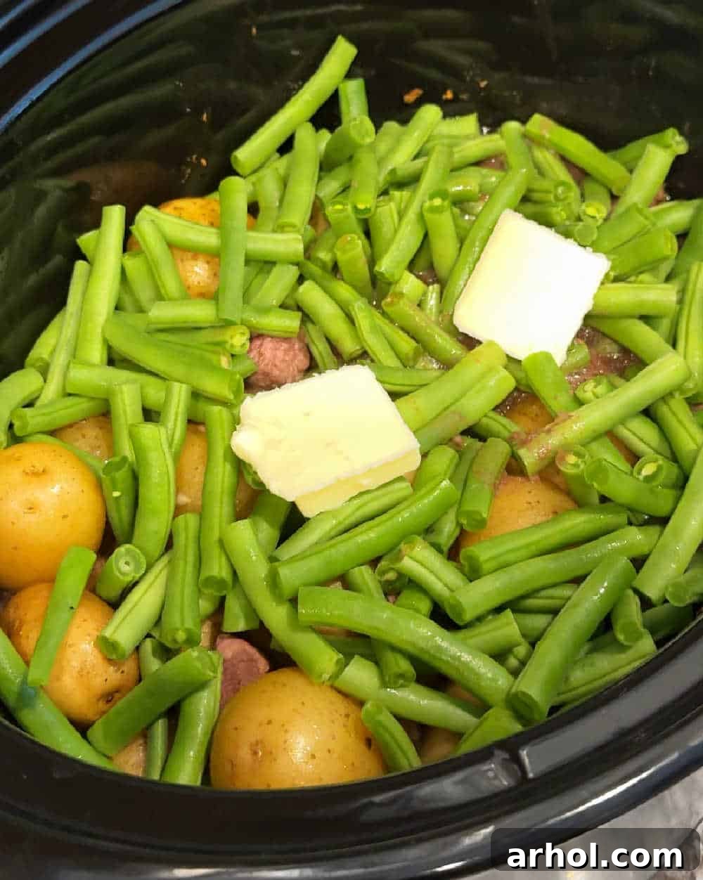 Green beans and butter added to the crockpot towards the end of cooking.