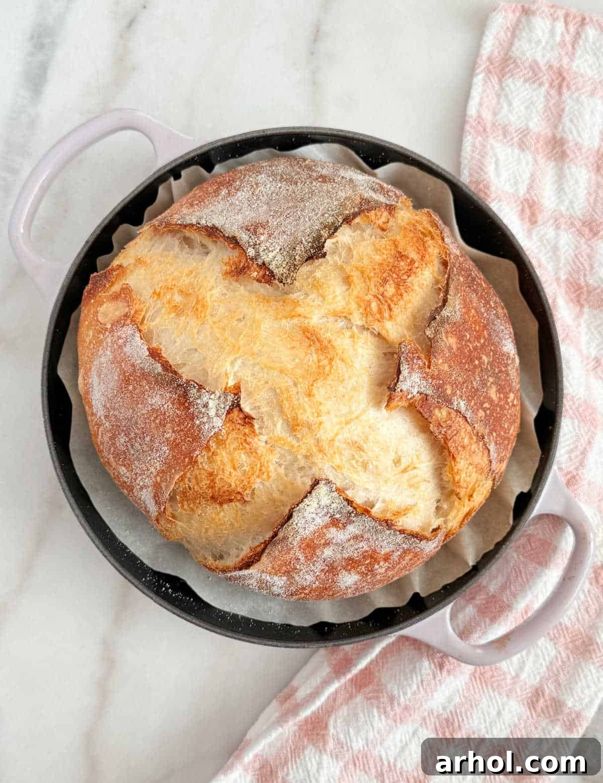 Freshly baked homemade sourdough bread, prepared and baked the same day in a bread oven, showcasing a beautiful crust and golden brown color.