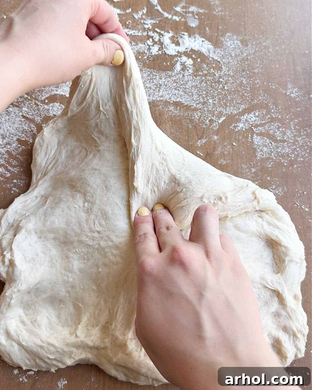 The process of shaping sourdough dough on a lightly floured surface, gently preparing it for its final form.