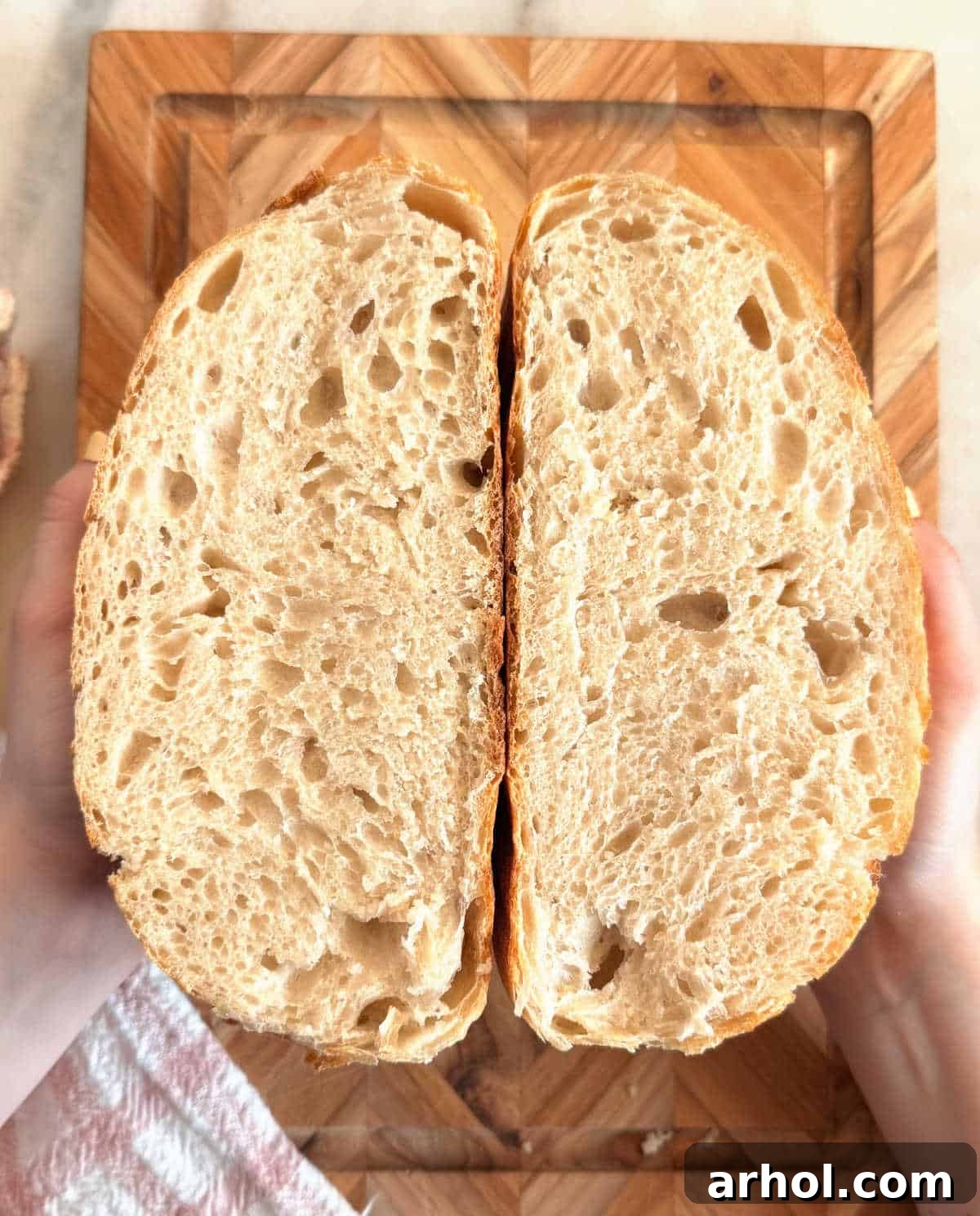 Inside crumb structure of a freshly baked same day sourdough bread loaf, showing its airy texture.