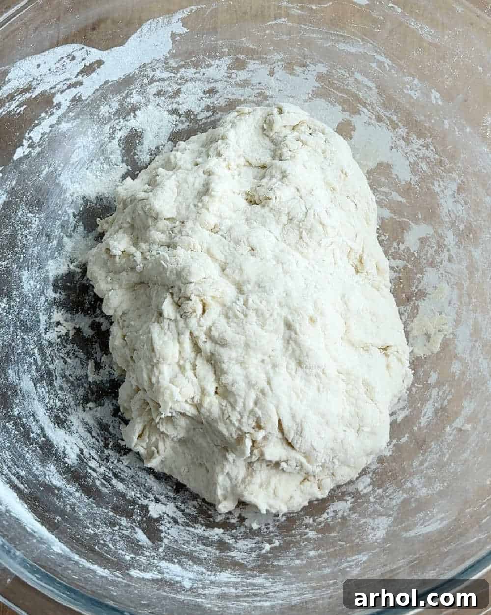 Shaggy bread dough in a mixing bowl after initial combining of ingredients, ready for resting.