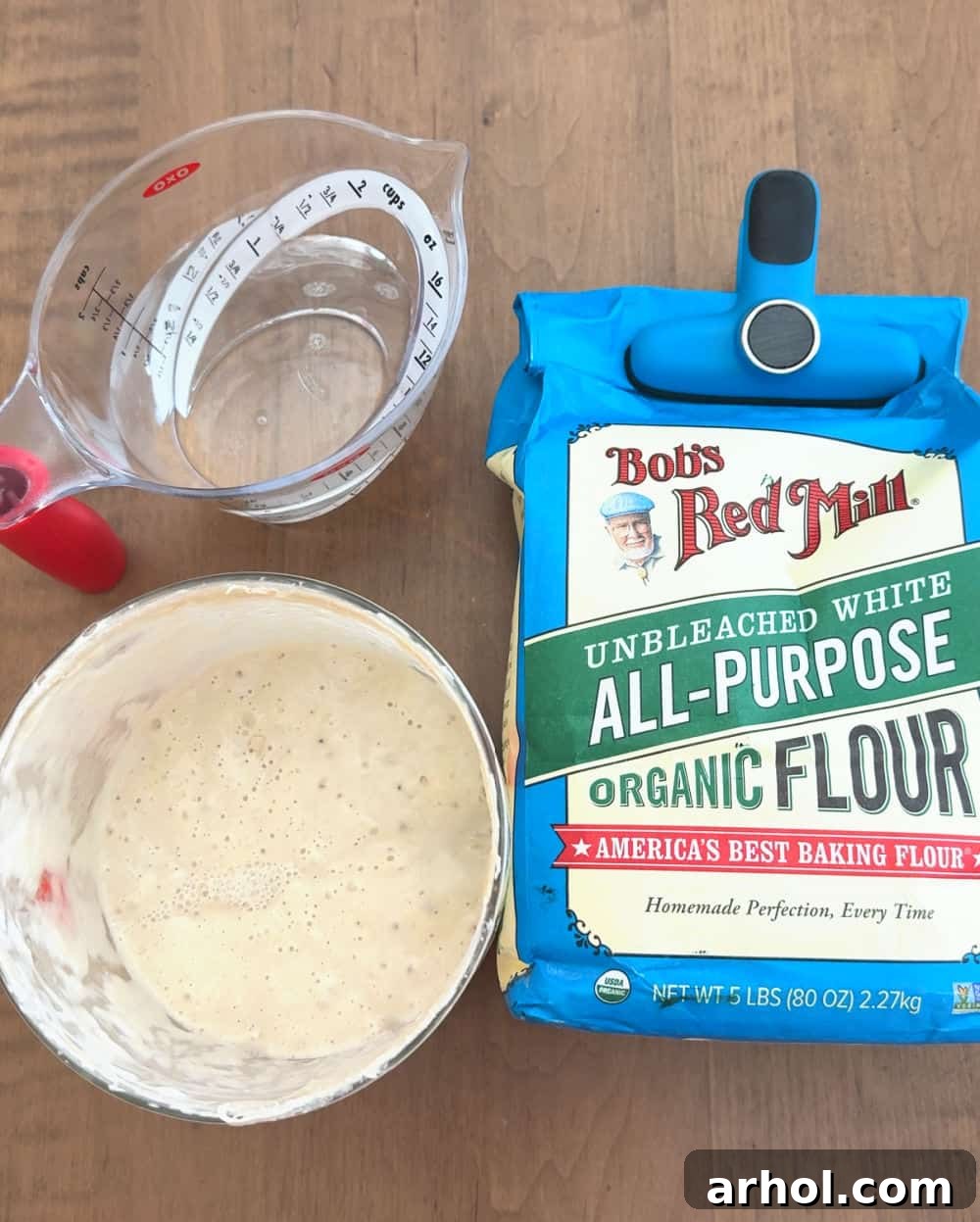 Ingredients: flour, water, and sourdough starter laid out for feeding.