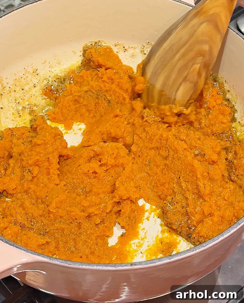 Effortless Pumpkin Pasta Perfection 6 Adding canned pumpkin puree into the Dutch oven with the melted butter and spices, stirring to combine for the pumpkin pasta sauce.