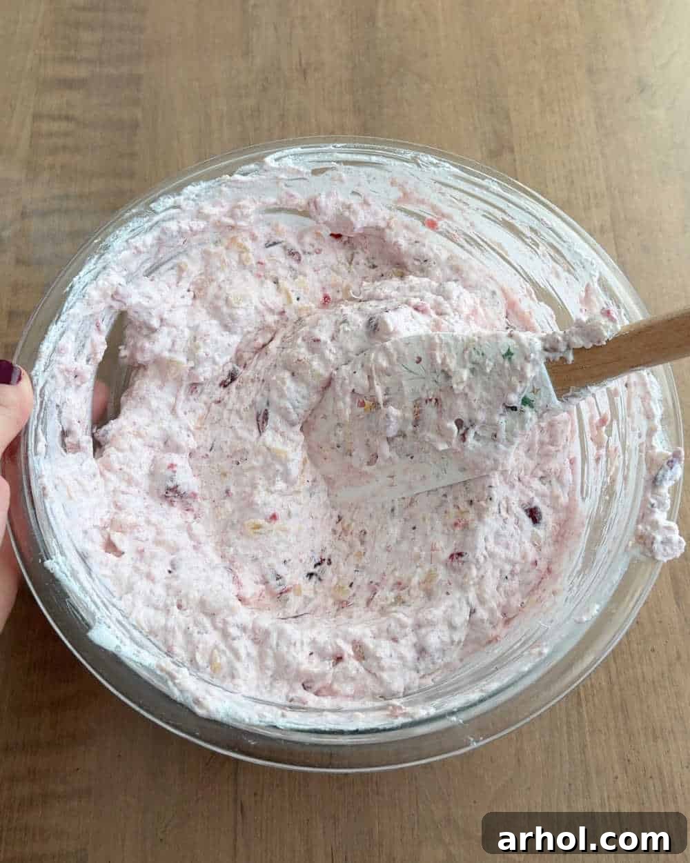Gently folding all the ingredients together in the mixing bowl until a consistent, fluffy, and beautifully pink mixture is perfectly formed.