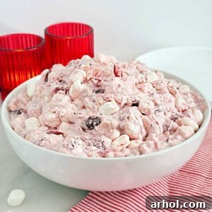 Cranberry fluff with cool whip and marshmallows in a bowl, ready to be served as a side dish or dessert.