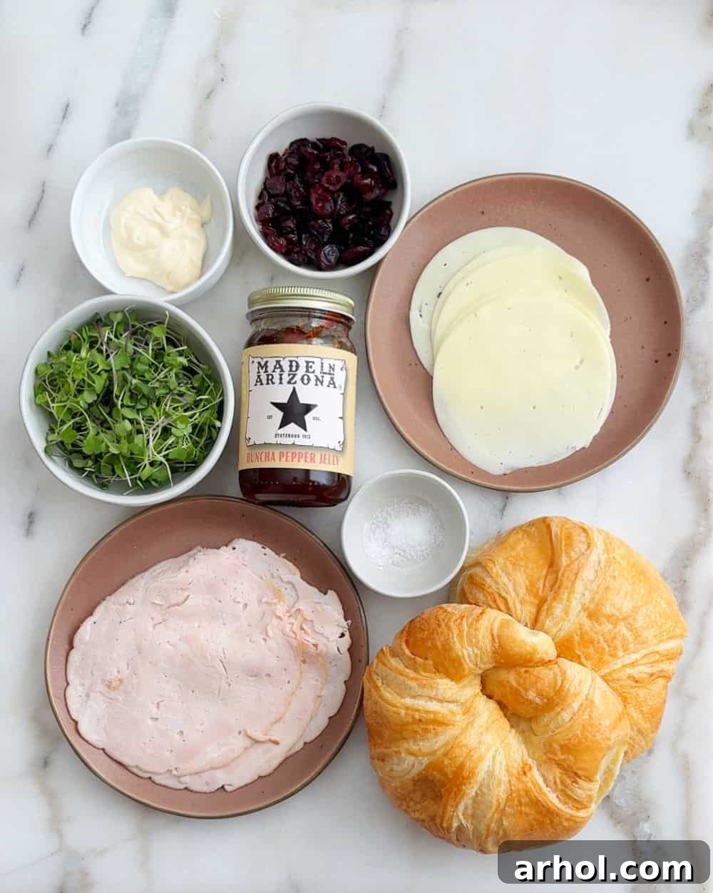 turkey meat, microgreens, mayo, craisins, salt, pepper jelly, cheese, croissants.
