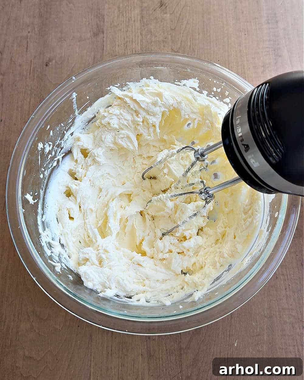 Spoonable Tiramisu Dream 6 Adding heavy cream and vanilla extract to the creamed cheeses, then mixing with an electric mixer until smooth and fluffy.
