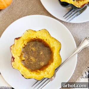 baked acorn squash with brown sugar and maple syrup on plate