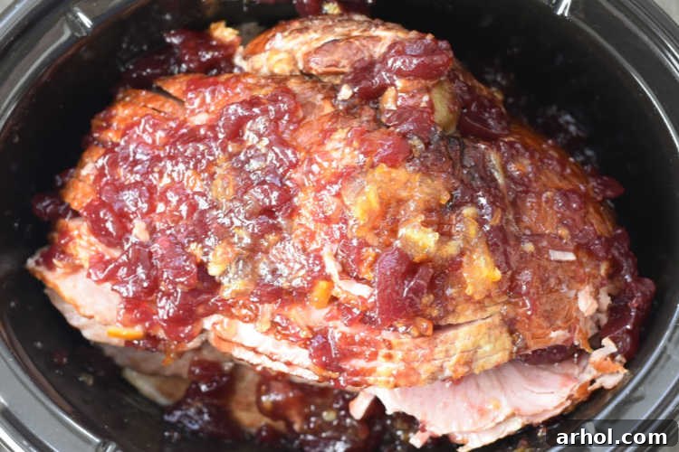 Christmas ham with jellied cranberry sauce and orange marmalade in slow cooker
