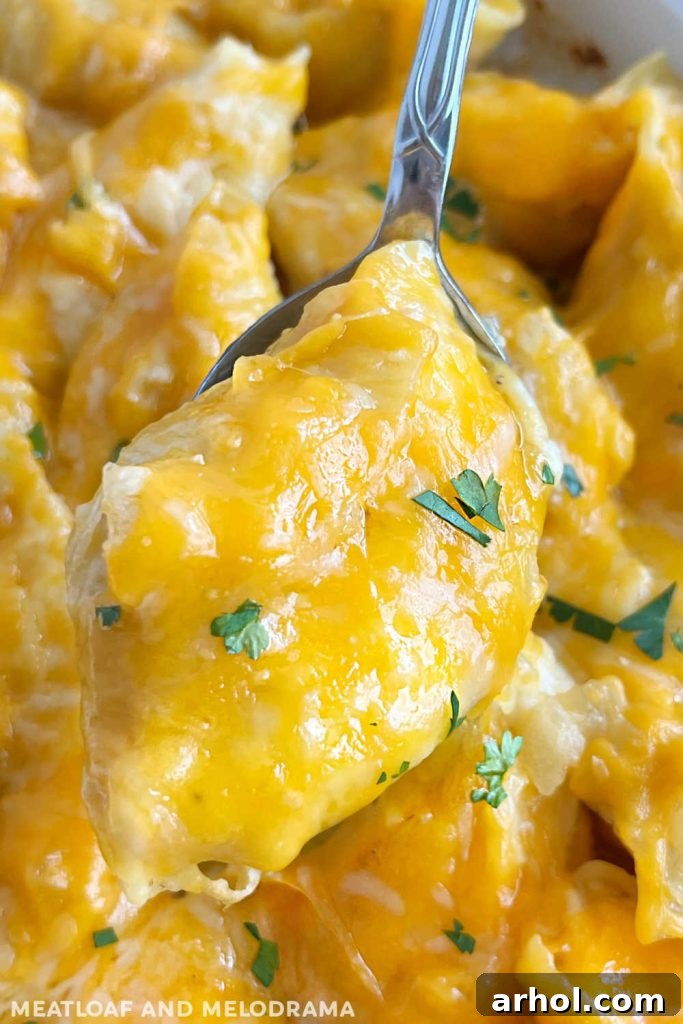 Baked lazy pierogi stuffed pasta shells topped with melted cheese on a serving spoon
