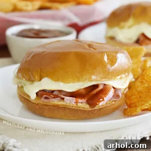 baked ham and cheese sliders with bbq sauce and melted provolone cheese