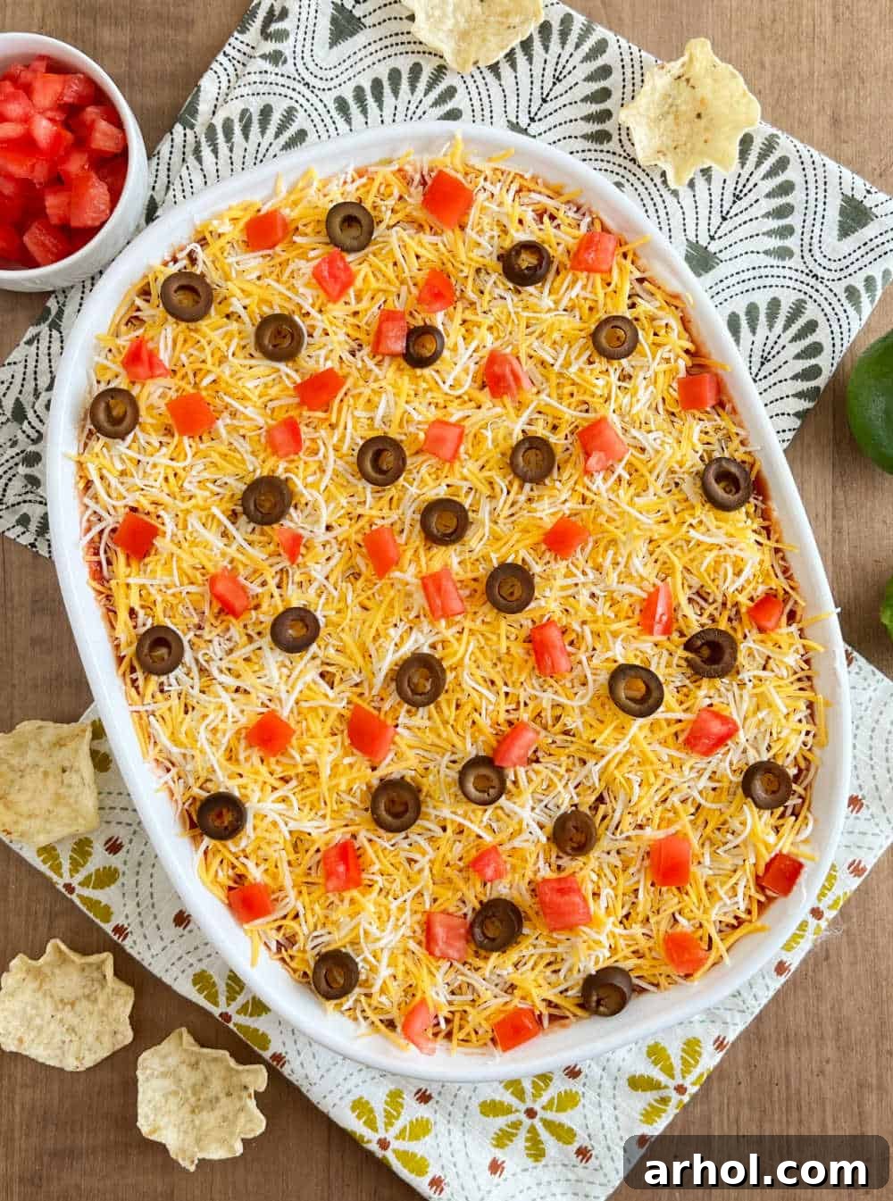 The finished seven-layer dip, showcasing vibrant, neat layers in a white baking dish, ready to be served.