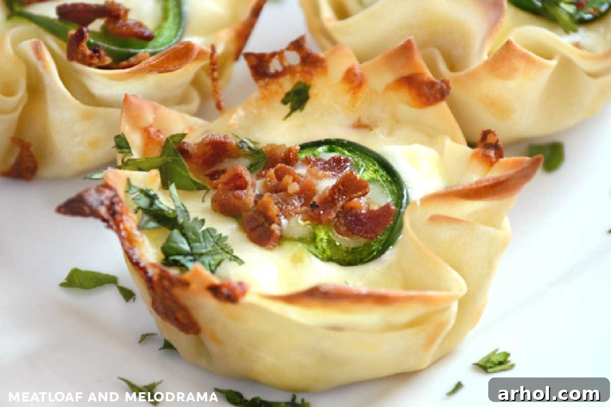 Crispy Jalapeño Popper Wonton Cups on a serving plate with cilantro and bacon bits for garnish