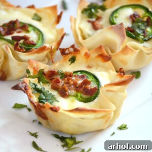 Jalapeno Popper Wonton Cups with Bacon on a plate, garnished with cilantro