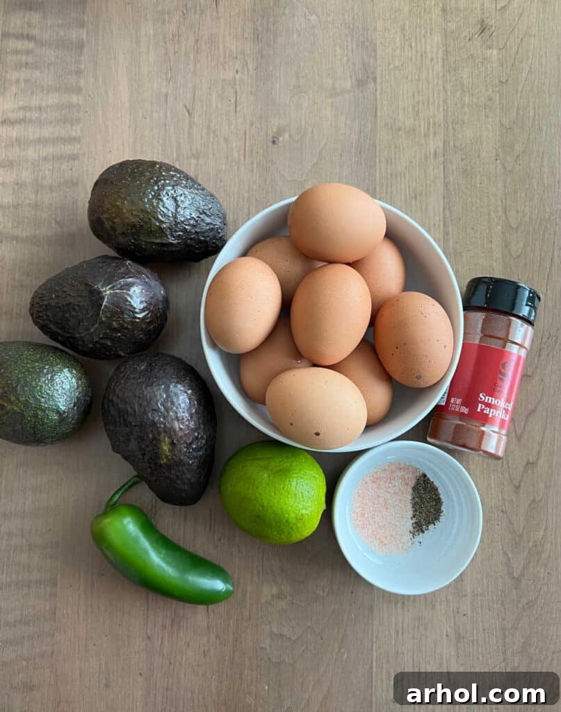Fresh Ingredients for Spicy Avocado Deviled Eggs hard boiled eggs, ripe avocados, jalapeno pepper, lime, spices.