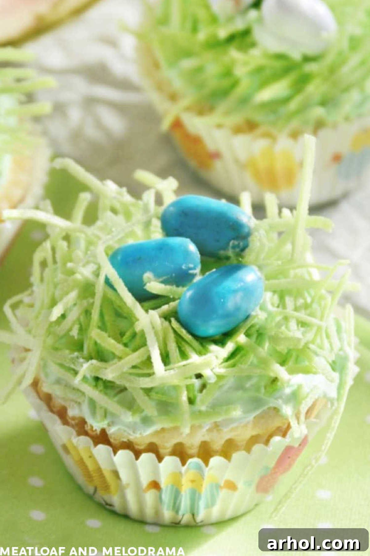 Adorable bird's nest Easter cupcakes with vibrant edible Easter grass and colorful chocolate mini eggs arranged on a festive table setting.