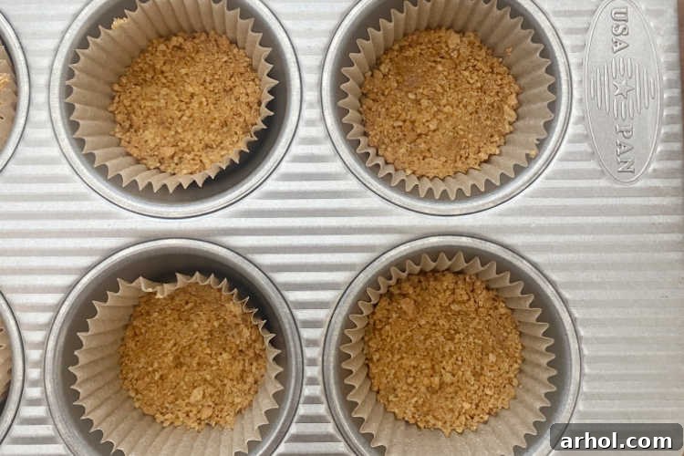 crushed graham crackers in muffin tin baking cups