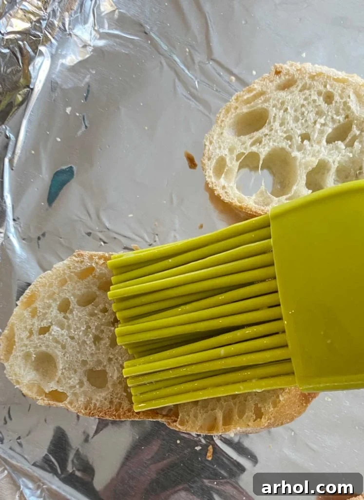 brush baguette slices with melted garlic butter