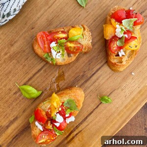 bruschetta toasts with fresh tomatoes and basil and feta cheese on wooden board