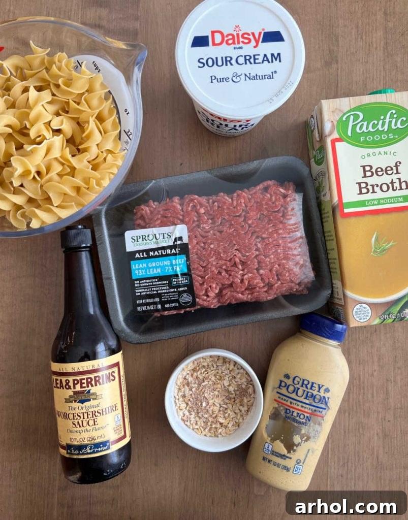 Better-Than-Boxed Ground Beef Stroganoff 3 Ground beef, egg noodles, sour cream, beef broth, mustard, Worcestershire sauce and seasonings laid out for Homemade Hamburger Helper Beef Stroganoff