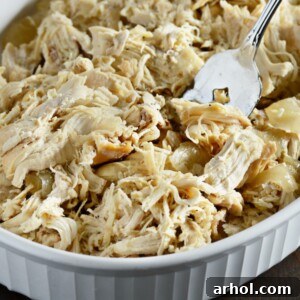 Perfectly cooked shredded chicken in a slow cooker, ready for meal prep